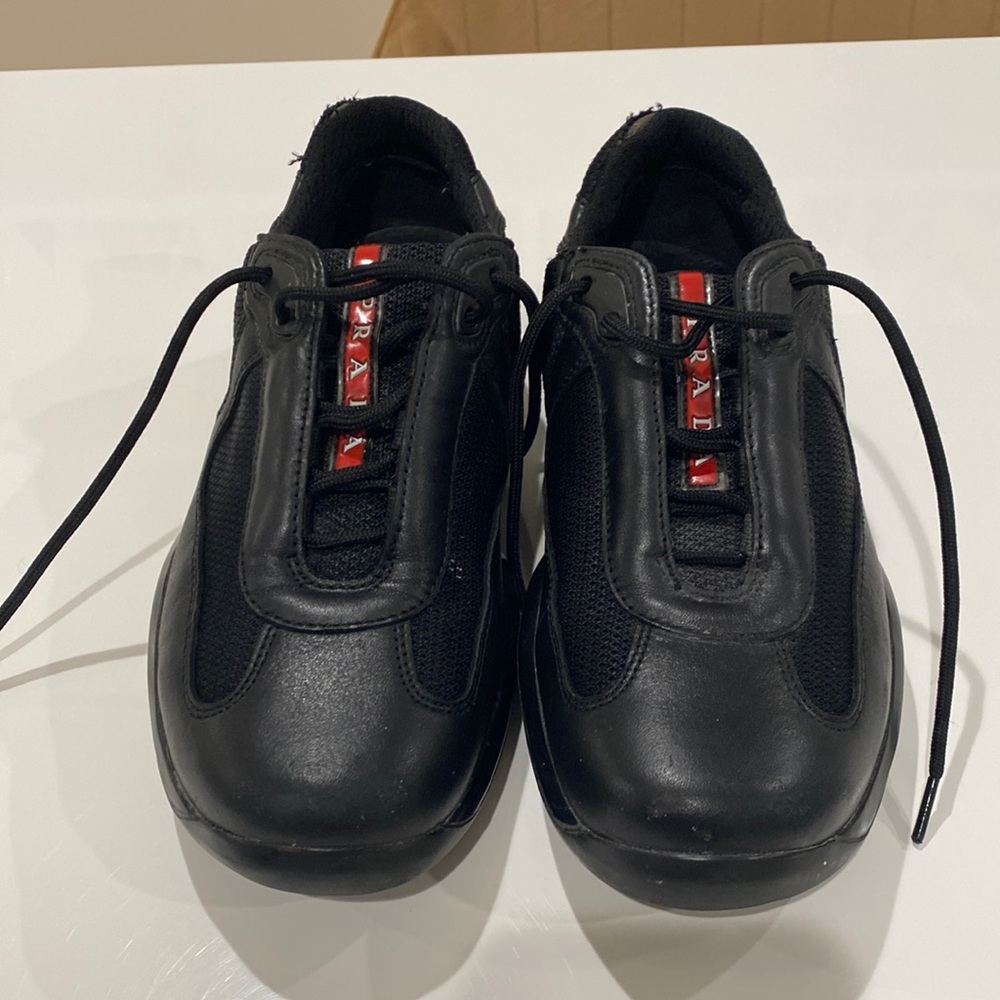 Authentic Prada sneaker size 36 (6) in black with red logo. Good condition.